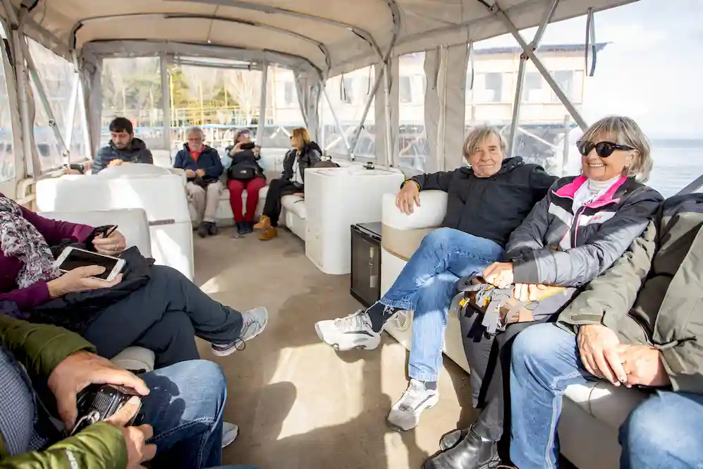 Se ve a varios turistas en un barco en el lago de Seván en Armenia que es una de las excursiones guiadas en Armenia que realiza Amistad Tour