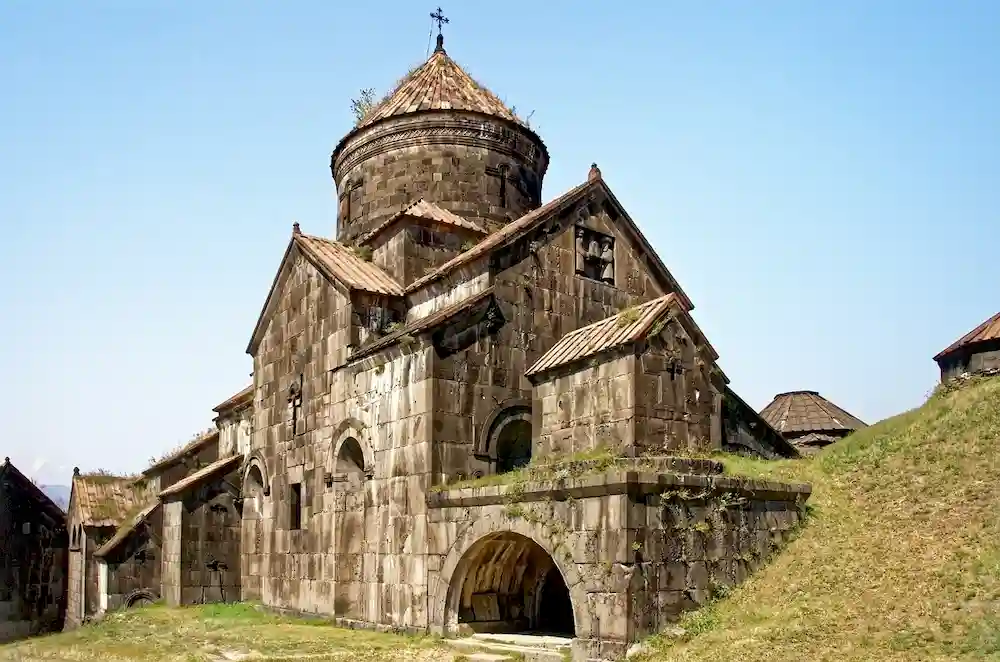 The exterior of Akhpat Monastery is shown on a sunny day
